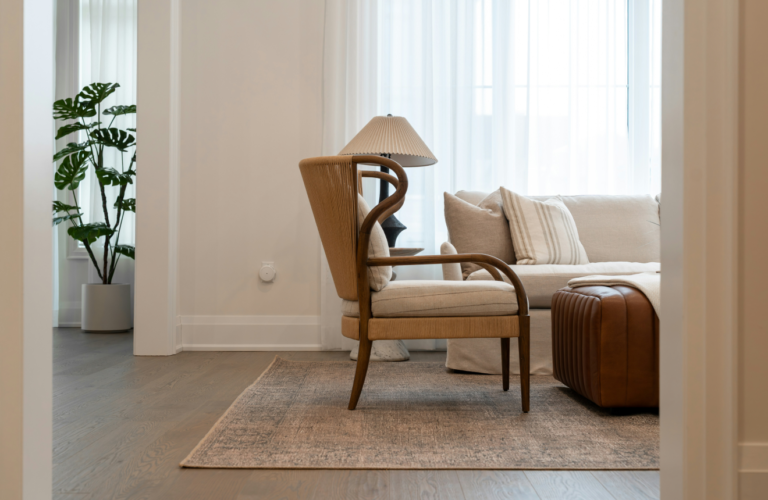 Cosy minimalist living room with neutral sofa large rug and warm floor lamp in corner