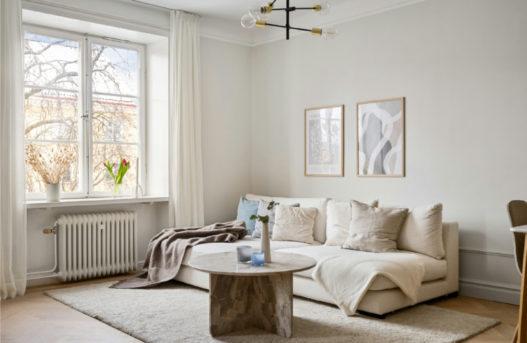 cosy minimalist living room with cream sofa and natural light