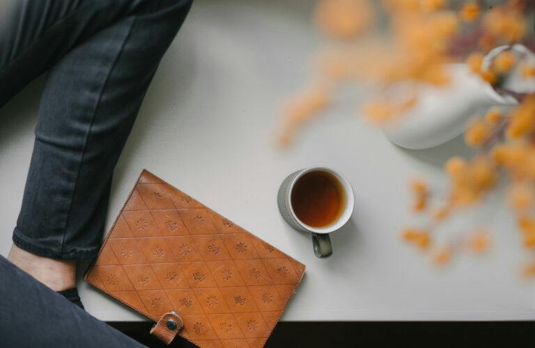 Warm morning scene with tea and leather journal