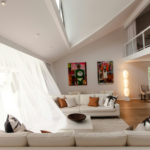Light airy summer living room with linen curtains indoor plants and fan creating a cool calm space
